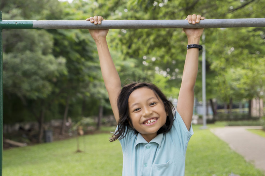 One way to practice gymnastics this summer is to do tap swings on the bars at your playground.